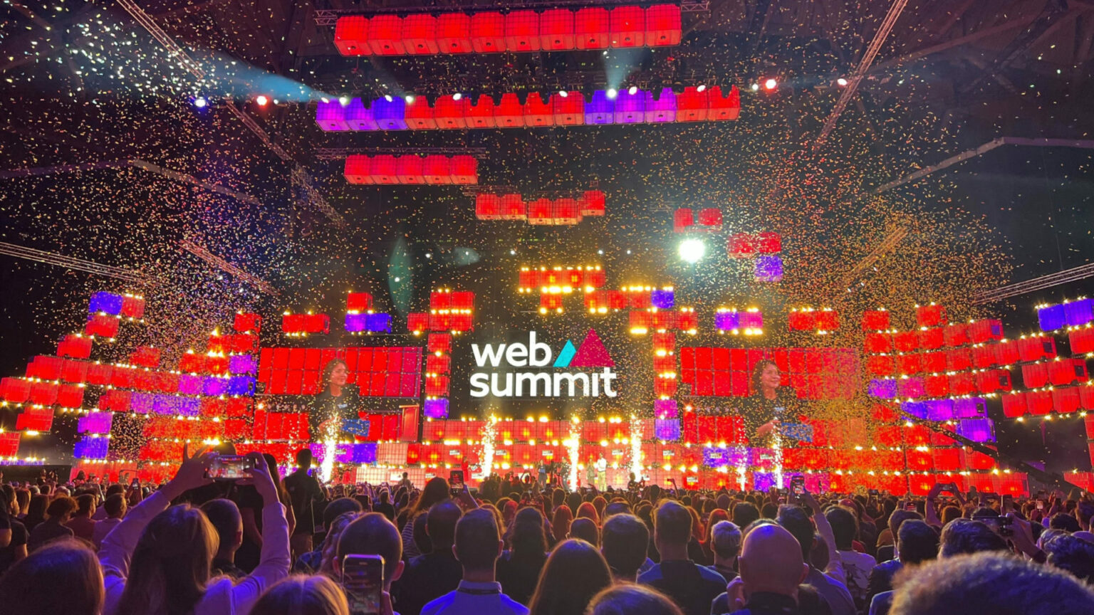 A vibrant scene at Web Summit Lisbon, showcasing thousands of attendees from diverse startups engaging in discussions, networking, and exploring innovative ideas in technology and entrepreneurship.